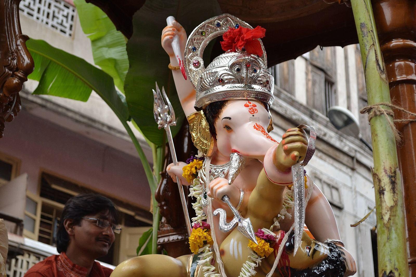 Festival idol of Bhau Rangari Ganpati, crowned and seated on a decorated throne